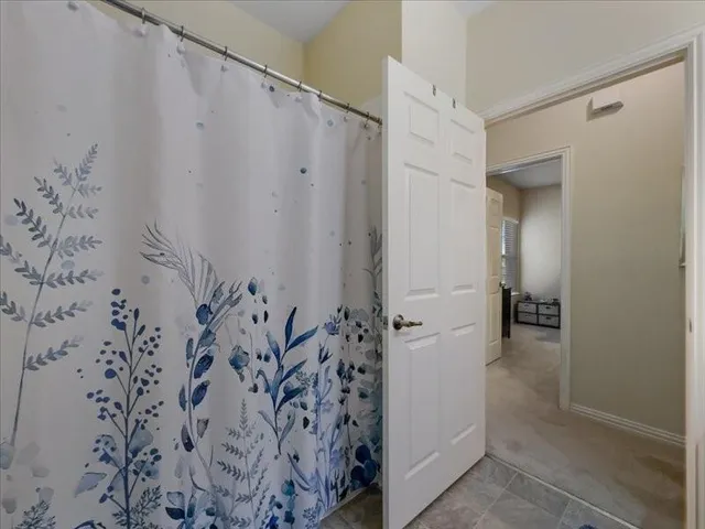 a bathroom with a shower and a sink