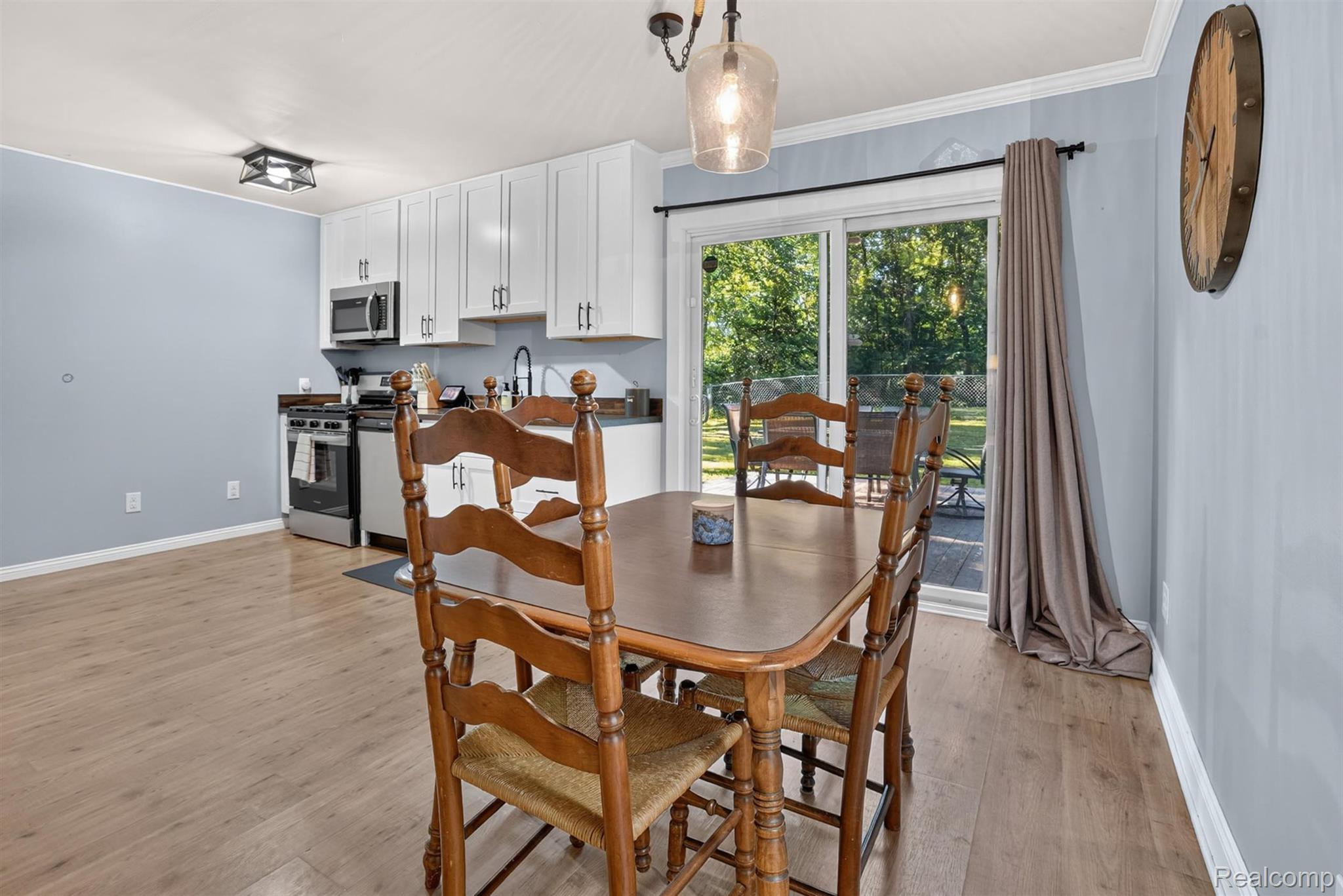 8696 West Sargent Road Fowlerville, MI 48836 - Photo 10 of 36 Dining area featuring wood-finish flooring and a contemporary pendant light fixture