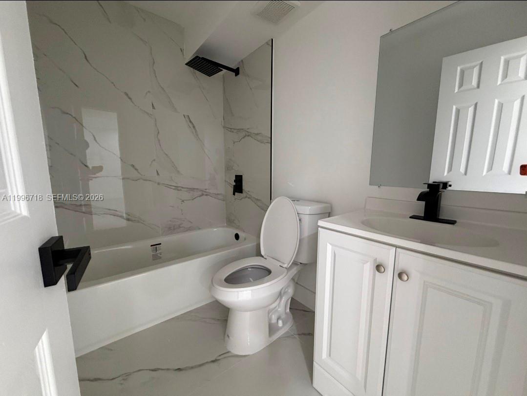 300 West 74th Place, Unit 217 Hialeah, FL 33014 - Photo 6 of 8 a bathroom with a sink a toilet and a bathtub