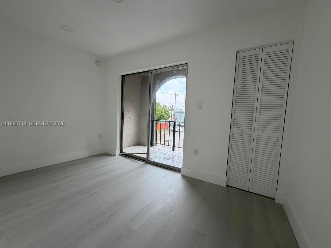 300 West 74th Place, Unit 217 Hialeah, FL 33014 - Photo 7 of 8 an empty room with windows