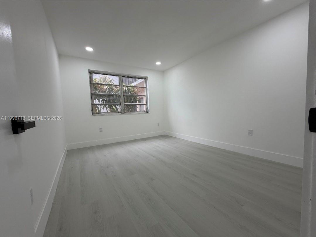 300 West 74th Place, Unit 217 Hialeah, FL 33014 - Photo 8 of 8 an empty room with a window