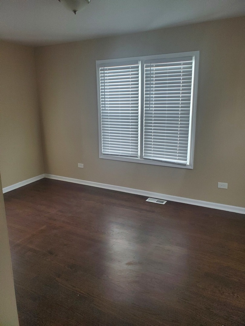 2422 12th Avenue Broadview, IL 60155 - Photo 11 of 34 a view of an empty room with wooden floor and a window