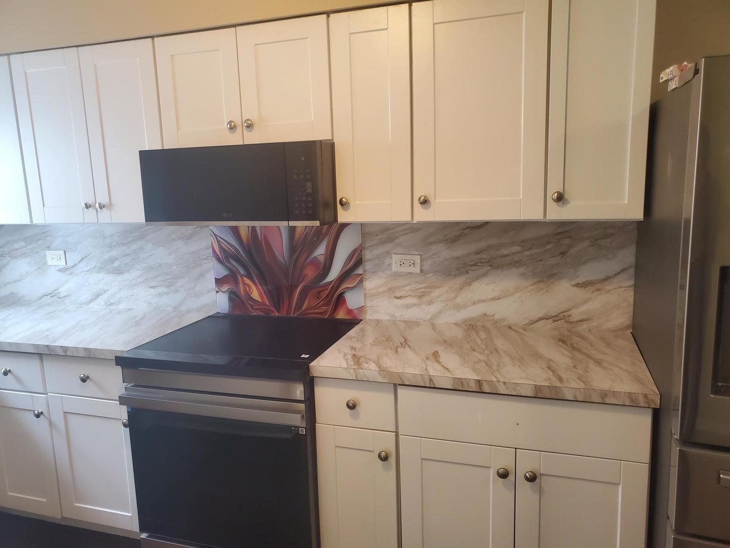 2422 12th Avenue Broadview, IL 60155 - Photo 13 of 34 a kitchen with granite countertop white cabinets and stainless steel appliances