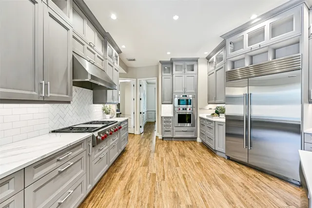 a spacious bathroom with a tub a mirror and a shower