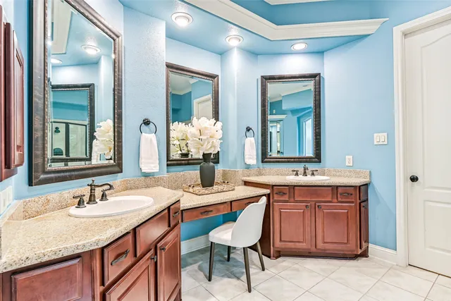 a bathroom with a granite countertop sink a mirror and a shower