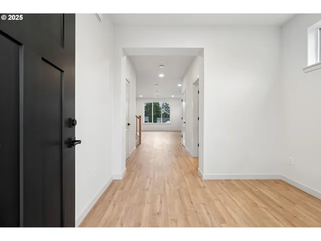 a view of a hallway with wooden floor