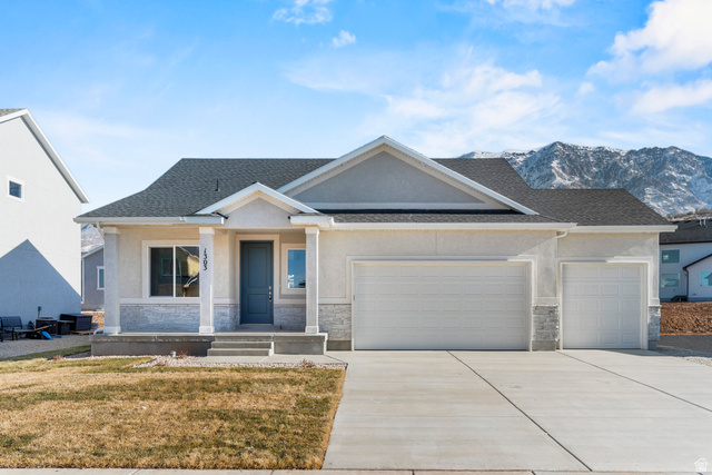 2823 North 710 West, Unit 16 Logan, UT 84321 - Photo 1 of 22 View of front of home with an attached garage, stone siding, stucco siding, driveway, and a front yard