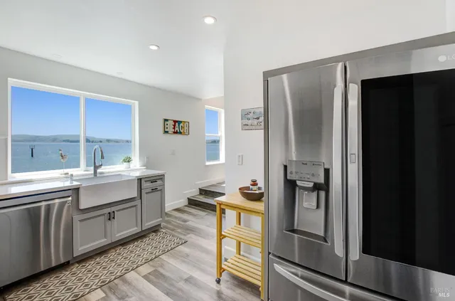 a kitchen with a refrigerator and a sink