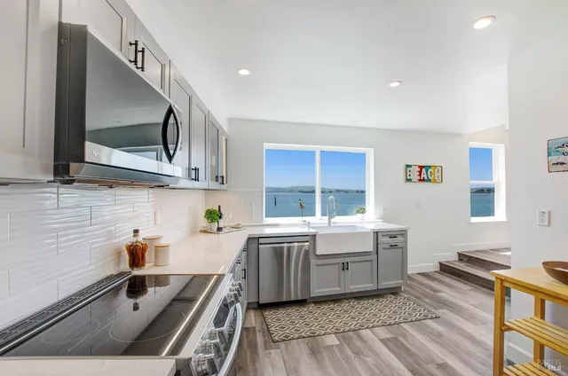 a kitchen with a sink appliances and cabinets