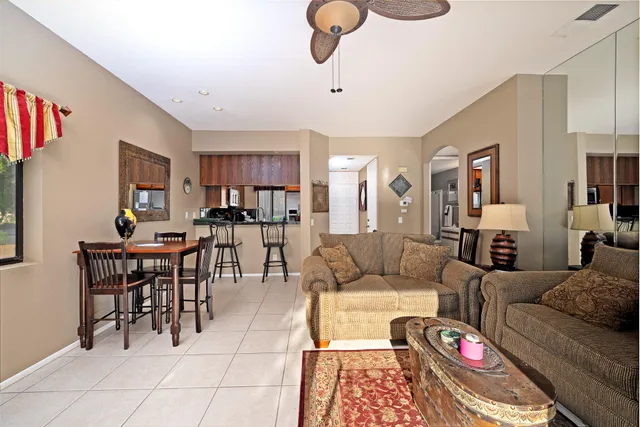 a living room with furniture kitchen view and a dining table