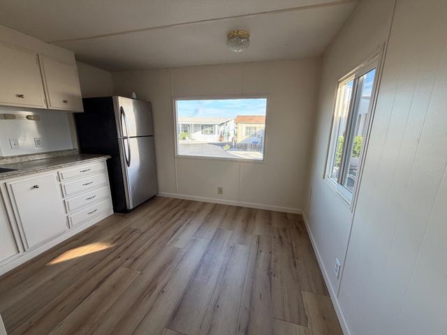 a view of kitchen with furniture and wooden floor