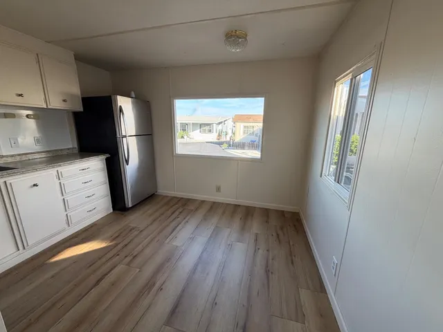 a view of kitchen with furniture and wooden floor