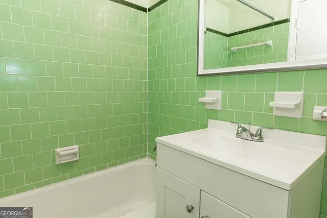 a bathroom with a sink a shower and a mirror