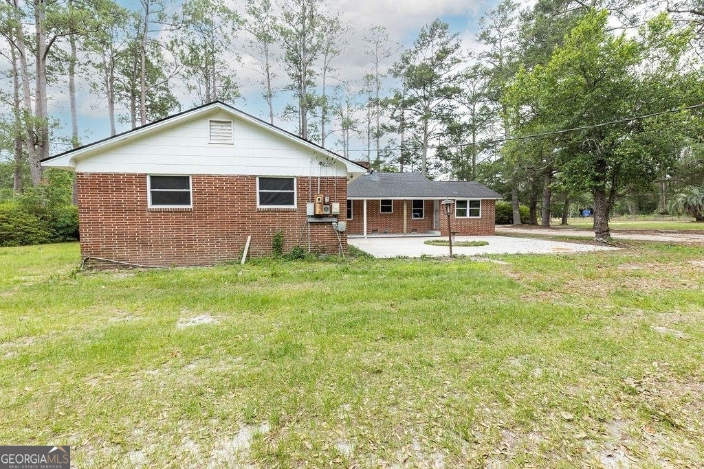405 Springfield Avenue Guyton, GA 31312 - Photo 31 of 39 a front view of a house with garden