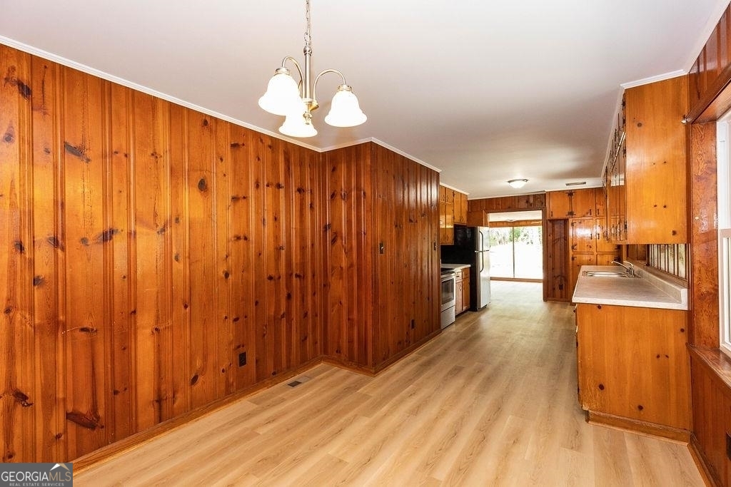 405 Springfield Avenue Guyton, GA 31312 - Photo 8 of 39 a view of a big room with wooden floor windows and a chandelier