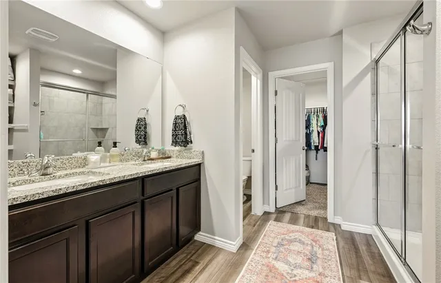 a bathroom with a double vanity sink and a mirror