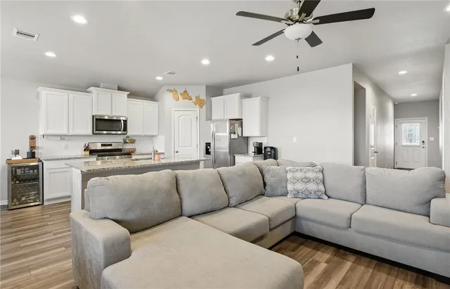 a living room with furniture and kitchen view