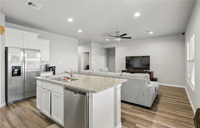 a view of kitchen with sink microwave and refrigerator