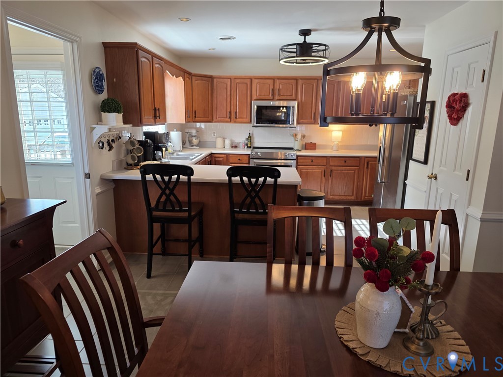 8511 Peaks Road Hanover, VA 23069 - Photo 21 of 48 a kitchen with sink refrigerator dining table and chairs