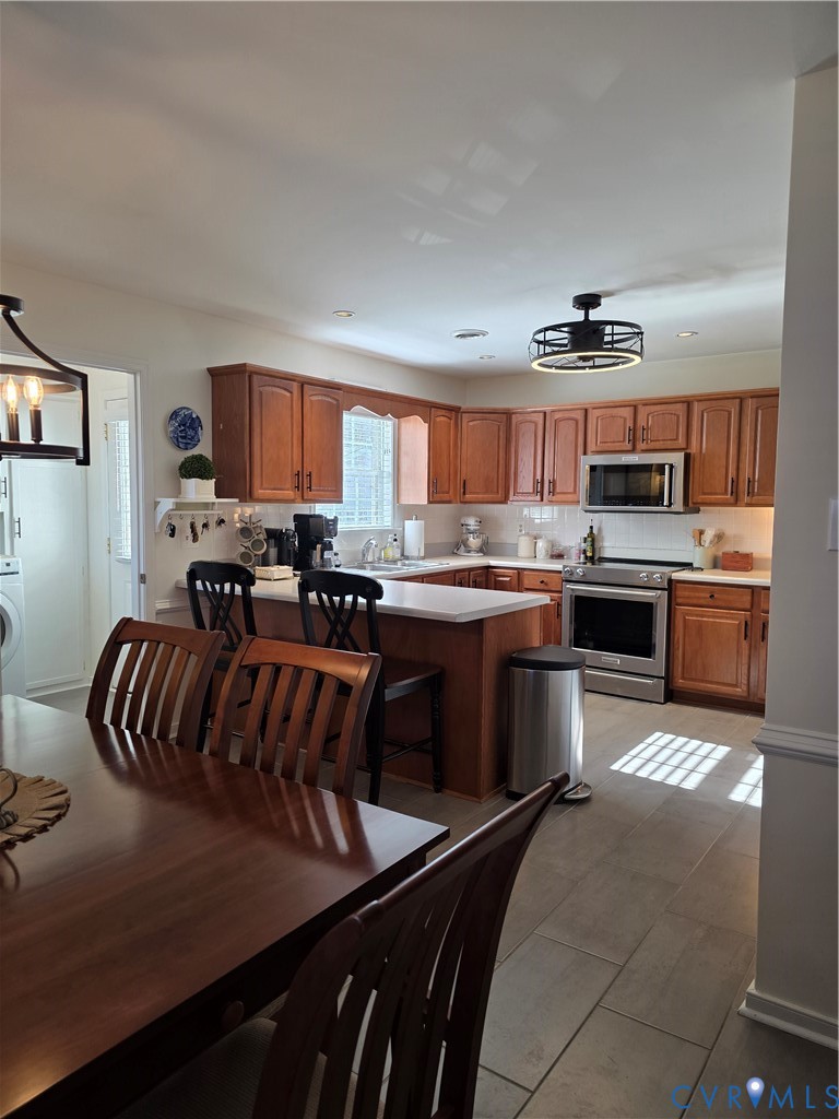 8511 Peaks Road Hanover, VA 23069 - Photo 25 of 48 a kitchen with stainless steel appliances granite countertop a stove a sink and a microwave