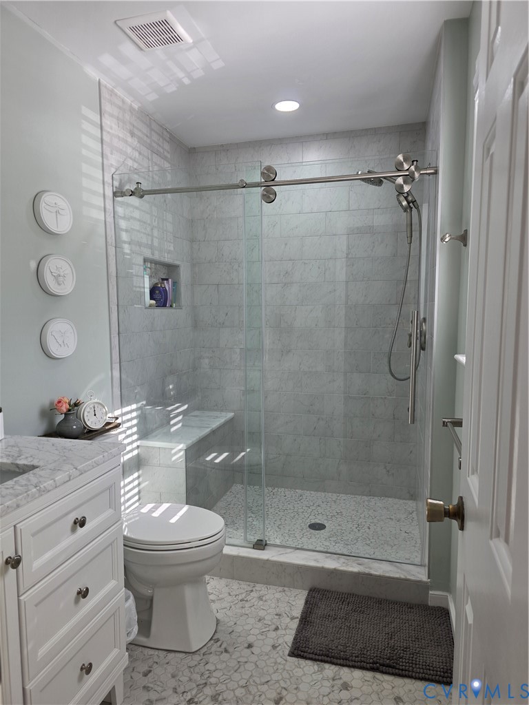 8511 Peaks Road Hanover, VA 23069 - Photo 35 of 48 a bathroom with a granite countertop toilet sink and shower