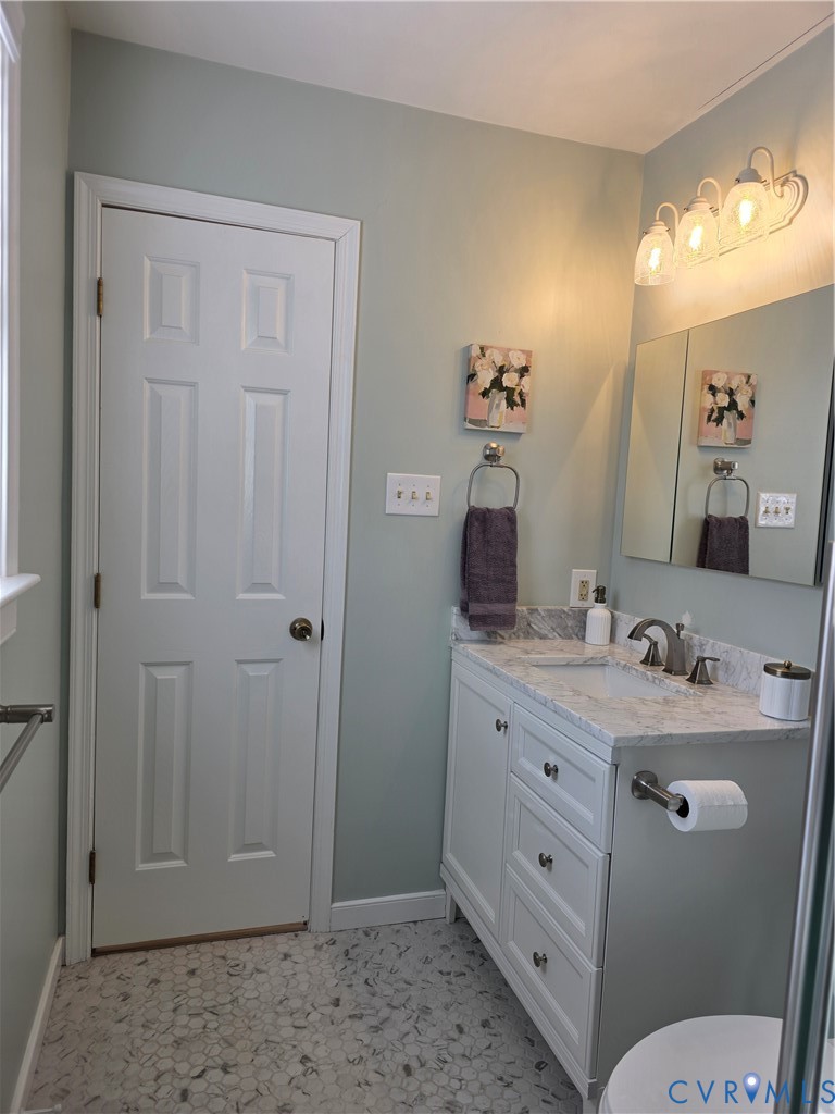 8511 Peaks Road Hanover, VA 23069 - Photo 40 of 48 a bathroom with a granite countertop sink toilet and mirror