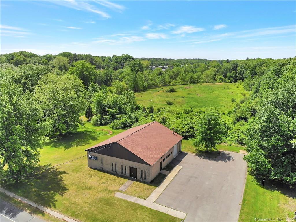 a view of a house with pool and a yard
