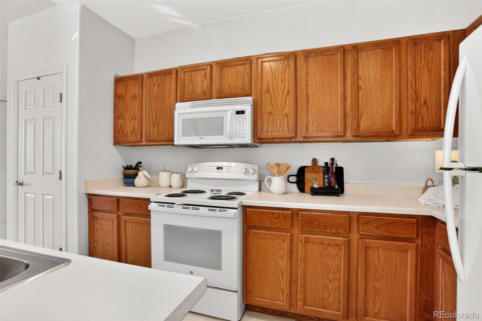 10715 Twenty Mile Road, Unit 202 Parker, CO 80134 - Photo 12 of 26 a kitchen with stainless steel appliances granite countertop a sink stove and cabinets