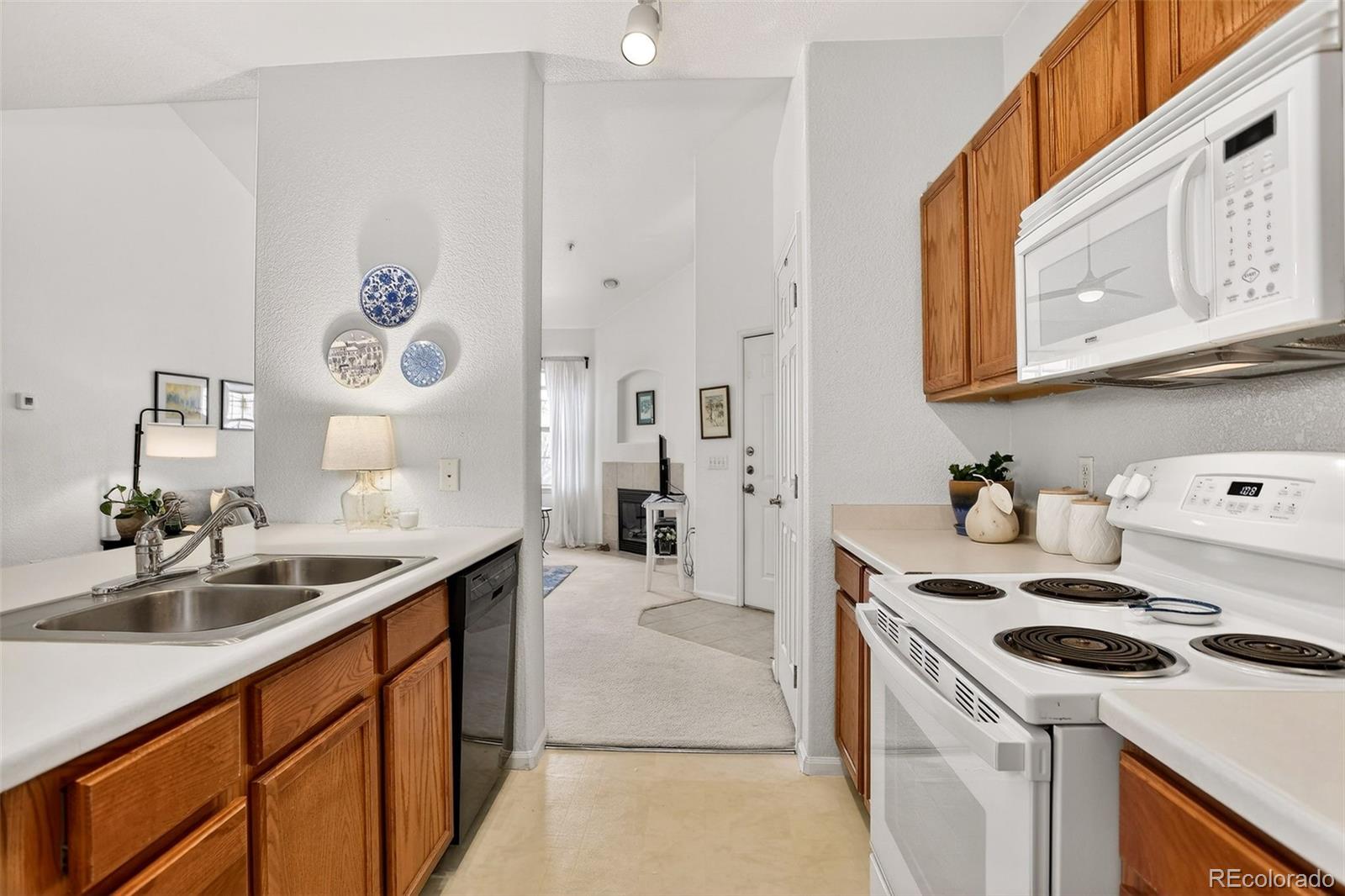 10715 Twenty Mile Road, Unit 202 Parker, CO 80134 - Photo 13 of 26 a kitchen that has a sink and a stove