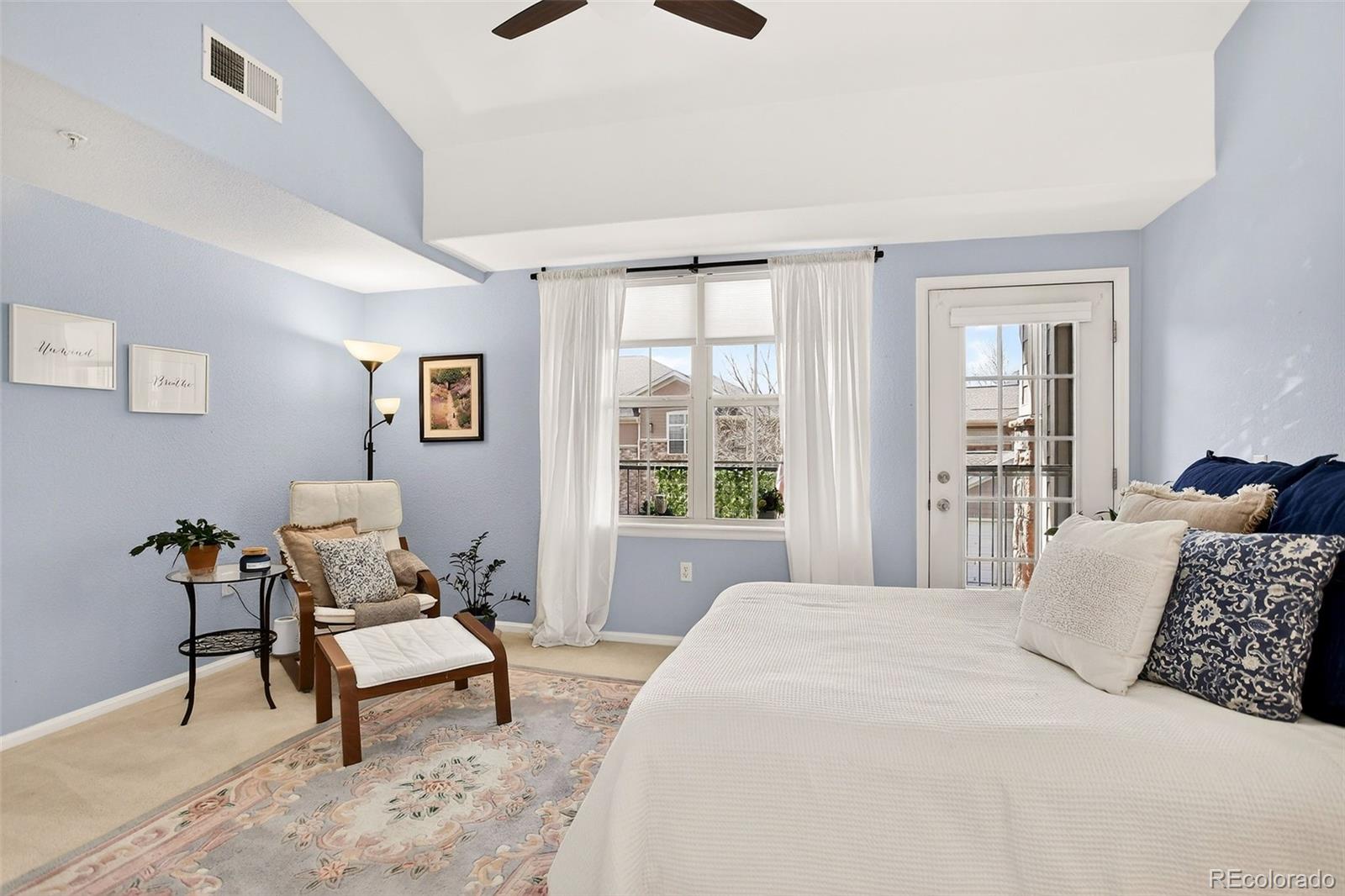 10715 Twenty Mile Road, Unit 202 Parker, CO 80134 - Photo 16 of 26 a bedroom with a bed and a window
