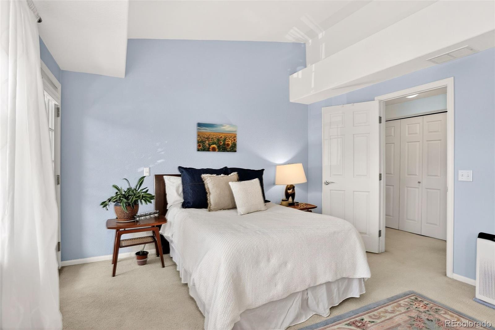10715 Twenty Mile Road, Unit 202 Parker, CO 80134 - Photo 17 of 26 a bedroom with a bed and painting on the wall