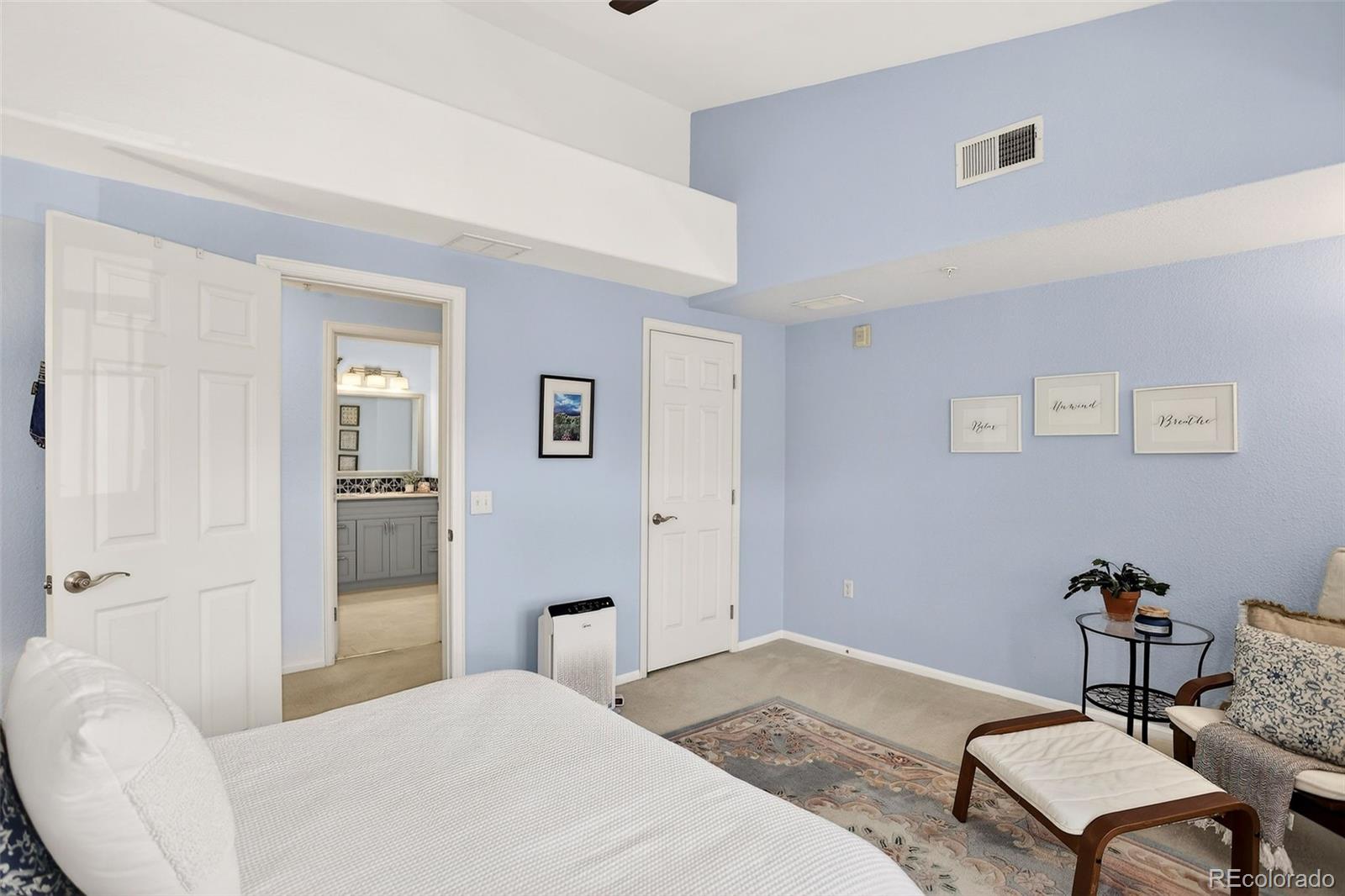10715 Twenty Mile Road, Unit 202 Parker, CO 80134 - Photo 18 of 26 a bedroom with a bed and furniture