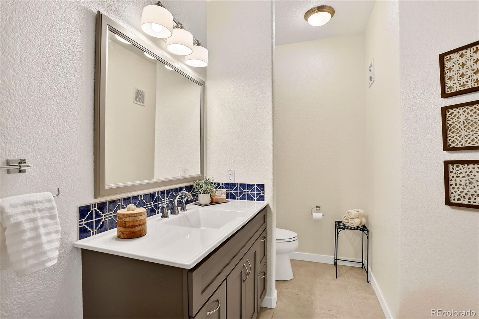 10715 Twenty Mile Road, Unit 202 Parker, CO 80134 - Photo 20 of 26 a bathroom with a sink and a mirror
