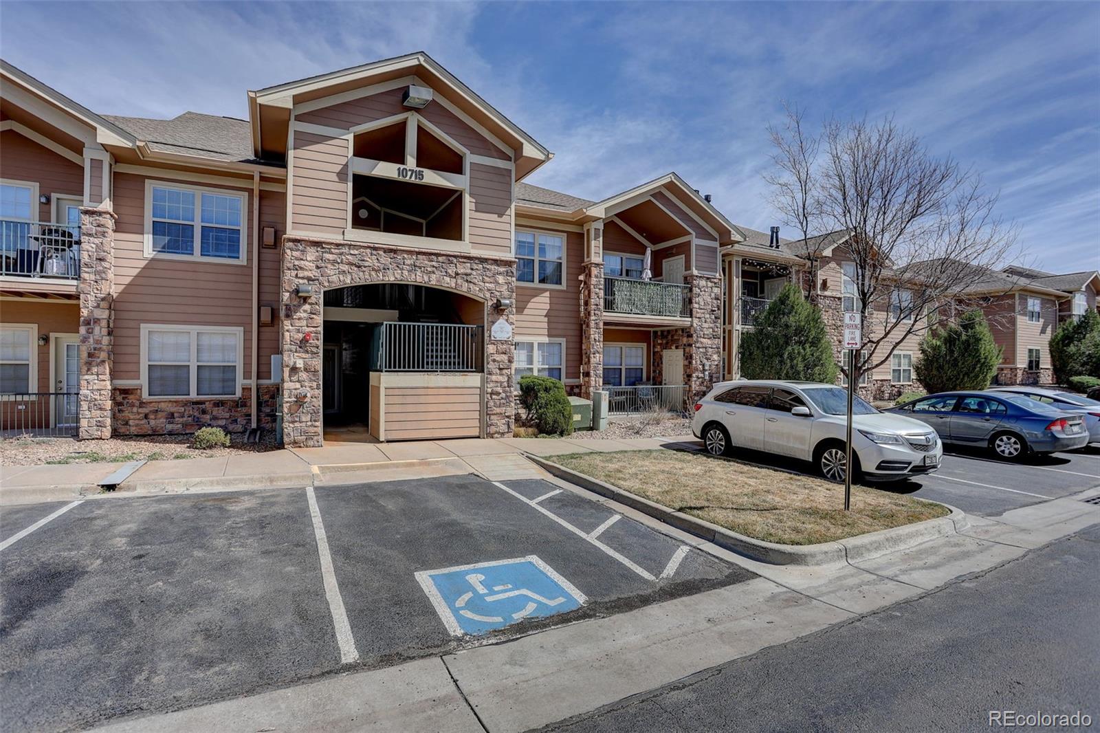 10715 Twenty Mile Road, Unit 202 Parker, CO 80134 - Photo 2 of 26 a view of a car park in front of house