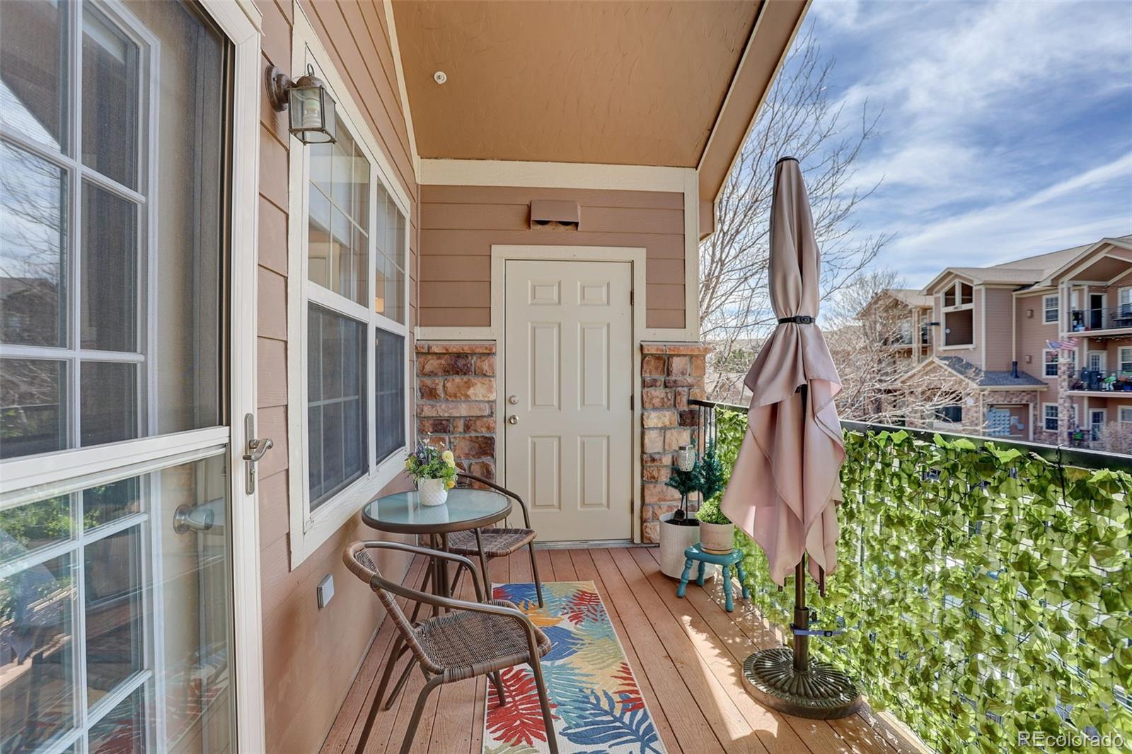 10715 Twenty Mile Road, Unit 202 Parker, CO 80134 - Photo 22 of 26 a backyard of a house with table and chairs