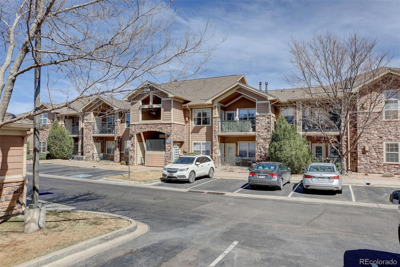 10715 Twenty Mile Road, Unit 202 Parker, CO 80134 - Photo 23 of 26 a car parked in front of a building