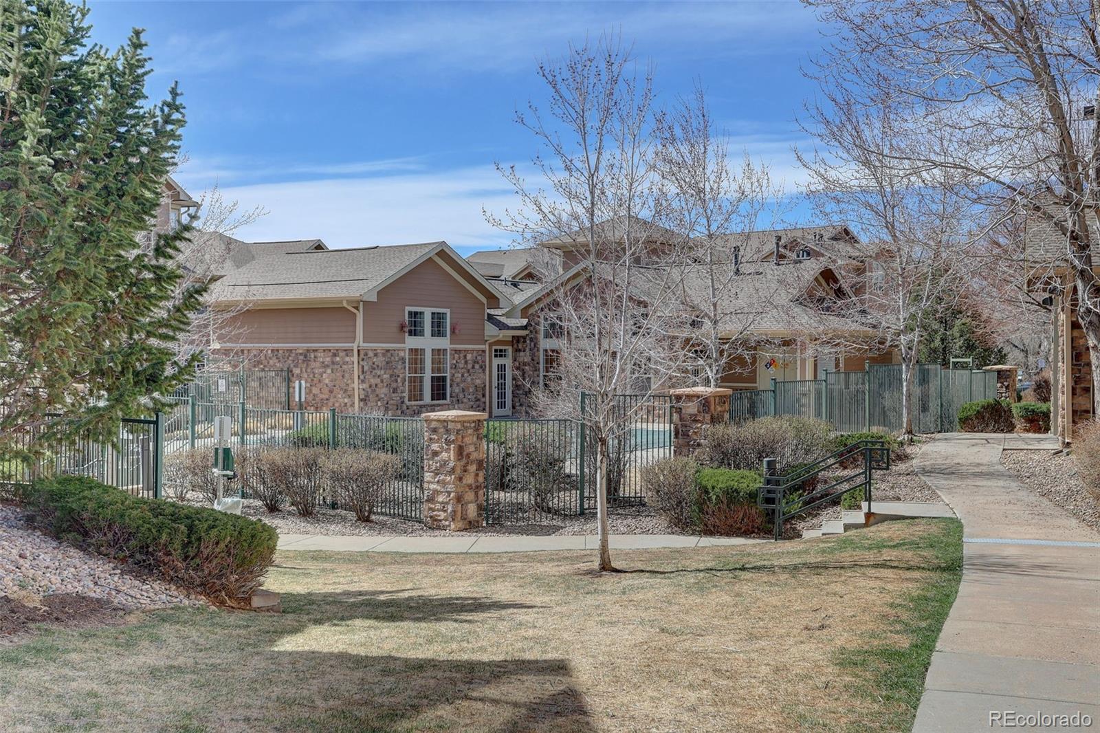 10715 Twenty Mile Road, Unit 202 Parker, CO 80134 - Photo 24 of 26 a front view of a house with a yard