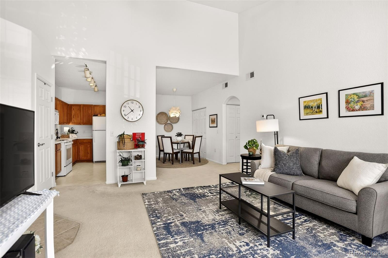 10715 Twenty Mile Road, Unit 202 Parker, CO 80134 - Photo 7 of 26 a living room with furniture and a flat screen tv