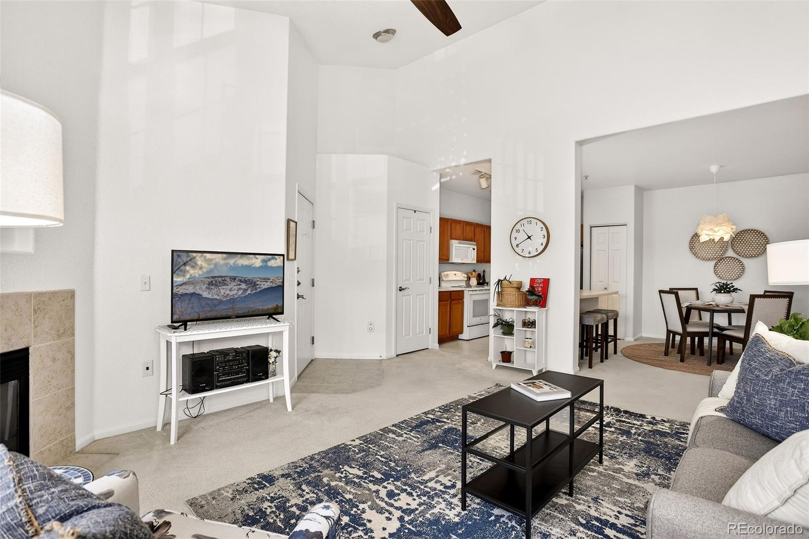 10715 Twenty Mile Road, Unit 202 Parker, CO 80134 - Photo 9 of 26 a living room with furniture and wooden floor