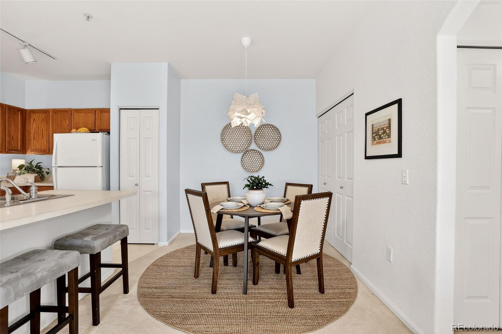 10715 Twenty Mile Road, Unit 202 Parker, CO 80134 - Photo 10 of 26 a view of a dining room with furniture