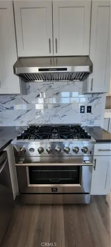 a stove top oven sitting inside of a kitchen