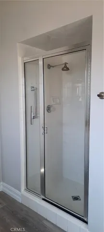 a bathroom with a glass shower door