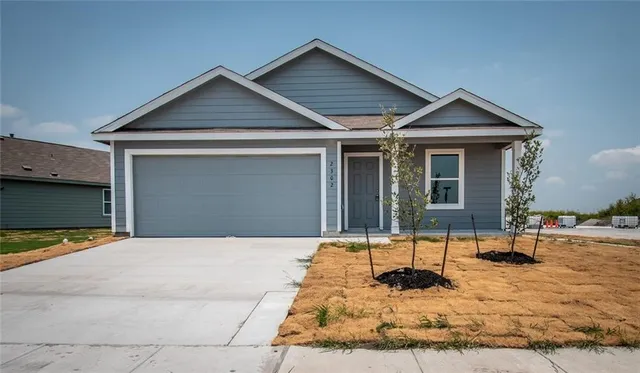a front view of a house with yard