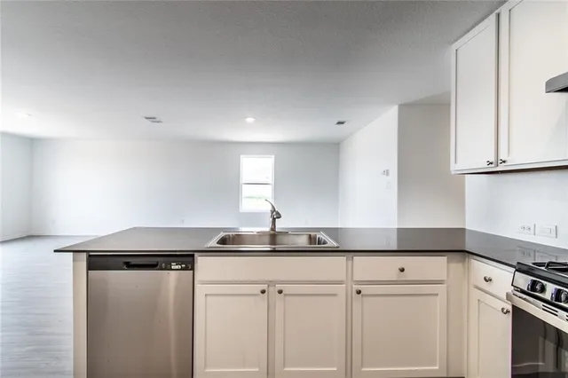 a kitchen with a sink and cabinets