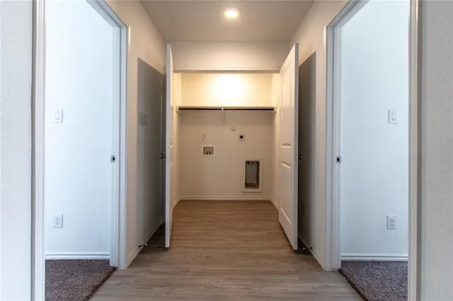 a view of a hallway with wooden floor