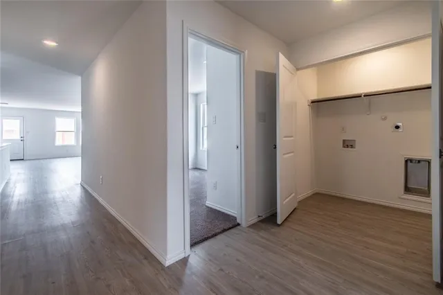 a view of hallway with wooden floor