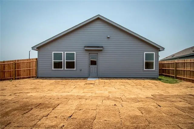a view of wooden fence and a house