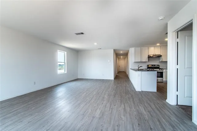 a view of kitchen with a sink a refrigerator and window