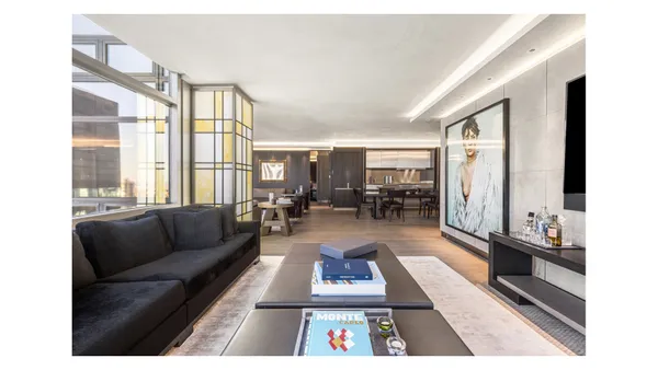 a living room with furniture rug dining table and a large window