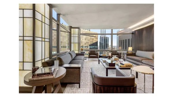 a living room with furniture a large window and a table